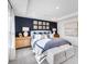 Elegant main bedroom with a blue accent wall, refined decor, and plenty of natural light at 1405 Windance Lake Dr, Loganville, GA 30052