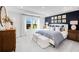 Luxurious main bedroom features a tray ceiling, a blue accent wall with tasteful decorations, and ample natural light at 1405 Windance Lake Dr, Loganville, GA 30052