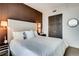Bedroom showcasing a large headboard, accent wall, and modern decor at 1820 Peachtree Nw St # 811, Atlanta, GA 30309