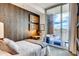 Bright bedroom with desk, modern décor, and sliding glass door to a private terrace at 1820 Peachtree Nw St # 811, Atlanta, GA 30309