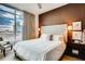 Bedroom with city view, brown accent wall, modern décor and great natural light at 1820 Peachtree Nw St # 811, Atlanta, GA 30309