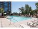 Relaxing outdoor pool with lounge chairs, umbrellas, and a view of the building at 1820 Peachtree Nw St # 811, Atlanta, GA 30309