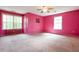 Spacious bedroom with plush carpeting, two large windows, and a ceiling fan at 4050 Old Fairburn Rd, Atlanta, GA 30349