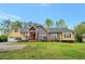 Charming brick and yellow-sided home with manicured lawn and inviting front porch at 4050 Old Fairburn Rd, Atlanta, GA 30349