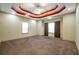 Spacious main bedroom featuring a tray ceiling and neutral carpet at 4050 Old Fairburn Rd, Atlanta, GA 30349
