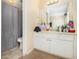 Bathroom featuring a shower and vanity with ample counter space for storage at 6433 Stone Terrace Ter, Morrow, GA 30260