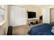 Bedroom with carpet, large closet, and a bed covered with a blue bedspread at 6433 Stone Terrace Ter, Morrow, GA 30260