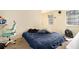 Bedroom with carpet, two windows, and a bed covered with a blue bedspread at 6433 Stone Terrace Ter, Morrow, GA 30260
