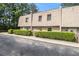 Exterior shot showcasing the front of the townhome and surrounding greenery at 6433 Stone Terrace Ter, Morrow, GA 30260