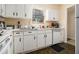 Galley style kitchen includes white cabinets and a bright sunny window at 6433 Stone Terrace Ter, Morrow, GA 30260