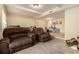 Spacious living room features a seating area, carpet flooring and ample light at 6433 Stone Terrace Ter, Morrow, GA 30260