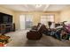Living room showcasing neutral carpet, natural light, and furnishings at 6433 Stone Terrace Ter, Morrow, GA 30260