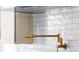 Beautiful golden pot filler set against white subway tile backsplash in luxury kitchen at 255 Mayfair Ct, Alpharetta, GA 30009