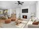 Bright living room with hardwood floors, fireplace, and open floor plan to kitchen and dining area at 255 Mayfair Ct, Alpharetta, GA 30009