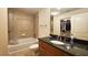 Well-lit bathroom with a granite vanity, shower over tub and ample storage at 3300 Windy Ridge Se Pkwy # 1121, Atlanta, GA 30339