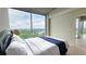 Bright bedroom with a large window showcasing scenic views and neutral decor at 3300 Windy Ridge Se Pkwy # 1121, Atlanta, GA 30339