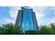 Contemporary high-rise condominium building featuring floor-to-ceiling windows and private balconies, set against a blue sky at 3300 Windy Ridge Se Pkwy # 1121, Atlanta, GA 30339