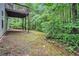 View of the backyard and lower deck with a wooded backdrop offering privacy and a natural setting at 377 Tapley Rd, Villa Rica, GA 30180