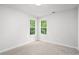 Bright bedroom featuring two windows offering ample natural light and neutral carpet at 377 Tapley Rd, Villa Rica, GA 30180
