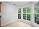 Eat-in kitchen area with light tile flooring, large windows, and wooded backyard views at 377 Tapley Rd, Villa Rica, GA 30180