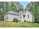 Inviting home exterior featuring lush lawn, mature trees, and meticulous landscaping at 377 Tapley Rd, Villa Rica, GA 30180