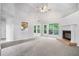 Bright living room with vaulted ceilings, neutral carpet, a fireplace, and backyard views at 377 Tapley Rd, Villa Rica, GA 30180