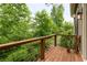 Charming wood balcony with a lush green view, perfect for relaxing outdoors at 385 Anders N, Chattahoochee Hills, GA 30268
