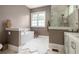 Well-lit bathroom featuring a modern soaking tub, walk-in shower, and neutral color palette at 385 Anders N, Chattahoochee Hills, GA 30268