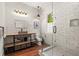 Modern bathroom with unique vanity, industrial lighting, and glass-enclosed shower, all in white brick at 385 Anders N, Chattahoochee Hills, GA 30268