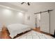 Modern bedroom featuring hardwood floors, white walls, and a barn door for an open feel at 385 Anders N, Chattahoochee Hills, GA 30268