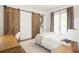 Bedroom with sliding barn doors that lead to a private bathroom and balcony at 385 Anders N, Chattahoochee Hills, GA 30268