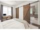 Comfortable bedroom featuring barn doors that lead to a private bathroom at 385 Anders N, Chattahoochee Hills, GA 30268