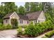 Charming single-story home featuring a lush green yard with well-manicured landscaping and a private driveway at 385 Anders N, Chattahoochee Hills, GA 30268