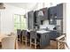 Stylish kitchen featuring gray cabinetry, a central island with seating, and stainless-steel appliances at 385 Anders N, Chattahoochee Hills, GA 30268