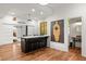 Kitchen featuring modern dark cabinets, updated appliances, and breakfast bar with seating at 385 Anders N, Chattahoochee Hills, GA 30268