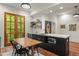 Kitchen with dark cabinets, wood table with chairs, wine fridge and french doors to the outside at 385 Anders N, Chattahoochee Hills, GA 30268