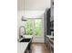 Modern kitchen with stainless steel appliances, stone countertops, and a view of the backyard at 385 Anders N, Chattahoochee Hills, GA 30268