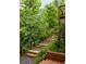 Beautiful landscaping with stone stairs and green foliage create a tranquil entrance at 385 Anders N, Chattahoochee Hills, GA 30268