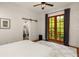 Bright main bedroom with en suite and a patio view featuring wood floors and a sliding barn door at 385 Anders N, Chattahoochee Hills, GA 30268