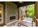 Outdoor patio with a brick fireplace and comfortable seating, perfect for entertaining guests at 385 Anders N, Chattahoochee Hills, GA 30268