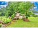 Backyard shed surrounded by lush landscaping and thriving foliage at 8140 Wood St Se, Covington, GA 30014