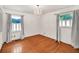 Bedroom featuring gleaming hardwood floors, soft gray walls, curtains, and a striking chandelier at 8140 Wood St Se, Covington, GA 30014