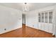 Cozy bedroom featuring hardwood floors, a closet, and a lovely chandelier at 8140 Wood St Se, Covington, GA 30014