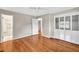 Bedroom featuring hardwood floors, neutral walls, a closet, and an ensuite bathroom at 8140 Wood St Se, Covington, GA 30014