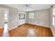 Bedroom features hardwood floors, neutral walls, a closet, and windows with mini-blinds at 8140 Wood St Se, Covington, GA 30014
