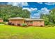 Charming brick home with a well-manicured lawn, offering a welcoming facade and inviting curb appeal in a peaceful neighborhood at 8140 Wood St Se, Covington, GA 30014