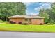 Charming brick home with manicured lawn, mature trees, and a welcoming entrance at 8140 Wood St Se, Covington, GA 30014