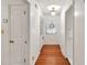 Entry hallway featuring hardwood floors, neutral walls, and classic lighting fixtures at 8140 Wood St Se, Covington, GA 30014