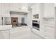 Bright kitchen features stainless appliances, white cabinetry, and stylish countertops at 8140 Wood St Se, Covington, GA 30014