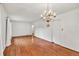 Bright, open living area featuring hardwood floors and elegant chandelier at 8140 Wood St Se, Covington, GA 30014